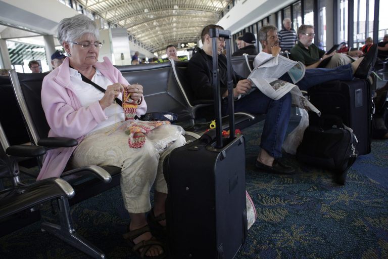 Penny MacDonald was supposed to depart Tampa International Airport on Monday April 22, 2013 at 1:40, but her flight to Toronto had been delayed to 3:10. She passed the time by knitting at the gate. A combination of furloughs of FAA air controllers due to sequestration and bad weather in the northeast caused hiccups in the commercial airline system on Monday. (AP Photo/The Tampa Bay Times, Edmund D. Fountain)