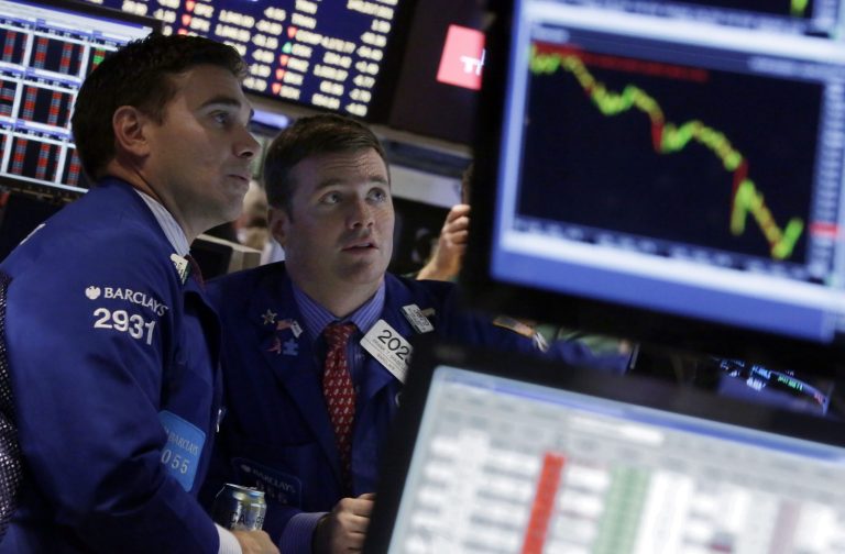FILE - In this Oct. 15, 2014 file photo, specialists Robert Tuccillo, left, and Frank Masiello work on the floor of the New York Stock Exchange. The biggest stock slump in more than two years is no reason to abandon the market, professional investors and strategists say. (AP Photo/Richard Drew, File)