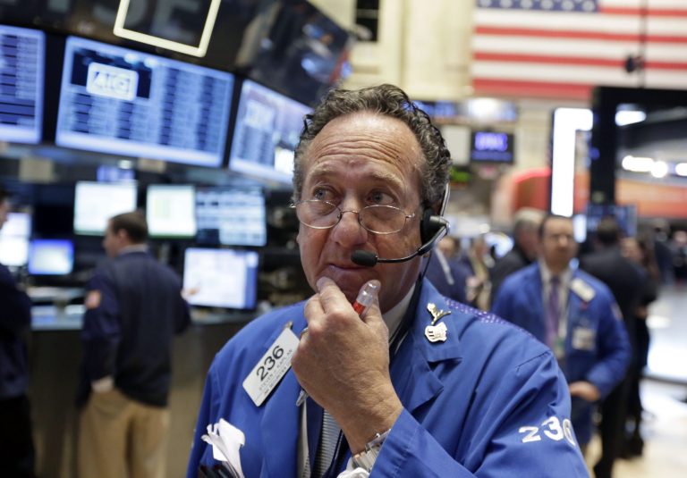 FILE - In this  Friday, March 14, 2014, file photo, trader Steven Kaplan works on the floor of the New York Stock Exchange. Global stocks fell Thursday March 20, 2014 after comments from the new head of the Federal Reserve suggested U.S. interest rates could rise sooner than financial markets were anticipating. (AP Photo/Richard Drew. File)