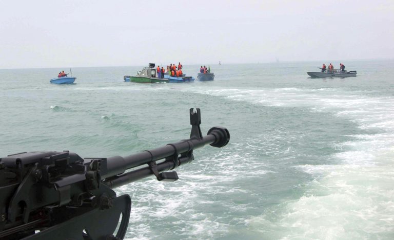 FILE- In this file photo taken on April 3, 2006, members of Iran's elite Revolutionary Guard attend  maneuvers in the Persian Gulf. Iran will target American aircraft carriers in the Persian Gulf should a war between the two countries ever break out, the naval chief of Iran's powerful Revolutionary Guard warned Tuesday as the country completes work on a large-scale mock-up of a U.S. carrier. (AP Photo/IRNA, File)