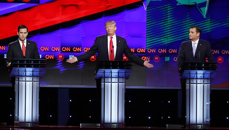 Republican presidential candidate, businessman Donald Trump, center, speaks as candidates, Sen. Marco Rubio, R-Fla., left, and Sen. Ted Cruz, R-Texas, right, listen, during the Republican presidential debate sponsored by CNN, Salem Media Group and the Washington Times at the University of Miami, Thursday, March 10, 2016, in Coral Gables, Fla. (AP Photo/Wilfredo Lee)