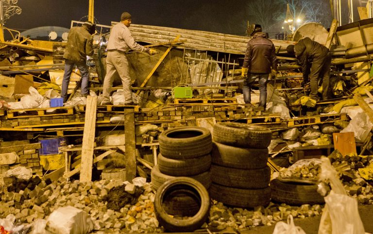 Anti-government protesters reinforce a barricade in central Kiev, Ukraine, late Thursday, Feb. 20, 2014. Protesters advanced on police lines in the heart of the Ukrainian capital on Thursday, prompting government snipers to shoot back and kill scores of people in the country's deadliest day since the breakup of the Soviet Union a quarter-century ago. (AP Photo/Darko Bandic)