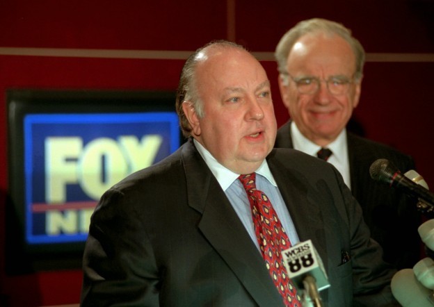 Roger Ailes, left, stands in front of News Corp. chief Rupert Murdoch at a conference after he was named chairman and CEO of News Corp.'s Fox News in 1996. AP Photo