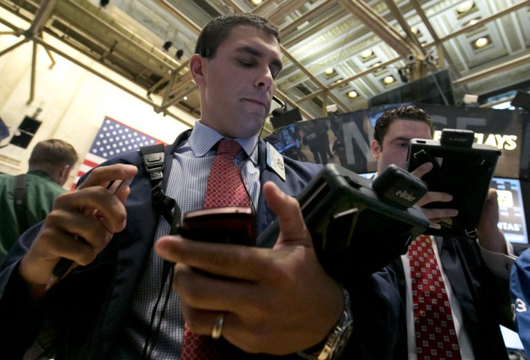 Trader Craig Spector, left, works on the floor of the New York Stock Exchange Wednesday, Aug. 6, 2014. U.S. stocks are little changed in early trading Wednesday as investors worry about escalating tensions between Russia and the Ukraine. Investors were also holding back after two larger merger bids were pulled. (AP Photo/Richard Drew)