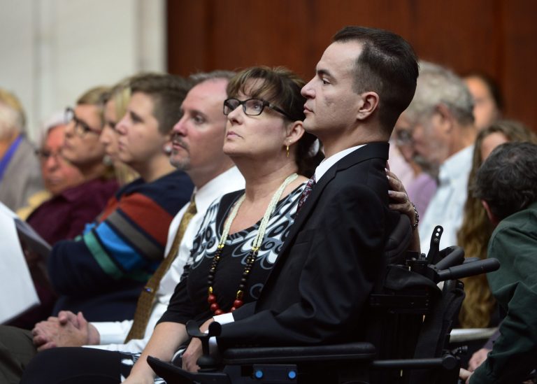 Brandon Coats, a quadriplegic medical marijuana patient who was fired by the Dish Network after failing a drug test more than four years ago, right, waits for the proceedings to begin with his mother, Donna Scharfenberg, at the Colorado Supreme Court in Denver on Tuesday, Sept. 30, 2014. Coats' case highlights the clash between state laws that are increasingly accepting of marijuana use and employers' drug-free policies that won't tolerate it. (AP Photo/The Denver Post, Kathryn Scott Osler, Pool)