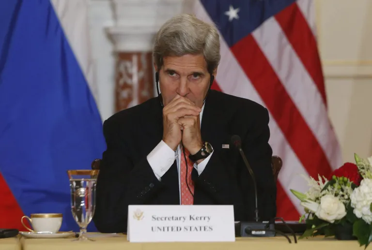   In this photo taken Aug. 9, 2013, Secretary of State John Kerry listens to translation as he meets with Russian Foreign and Defense ministers at the State Department in Washington, a sit-down tainted by the case of American National Security Agency leaker Edward Snowden, currently in Russia. This week on Kerry's first visit to South America as the Obama administration's chief diplomat, the disclosures by Snowden could chill talks on trade and energy, and even discussions about the Oct. 23 state dinner that President Barack Obama is hosting for Brazil's president, Dilma Rousseff. (AP Photo/Charles Dharapak)  