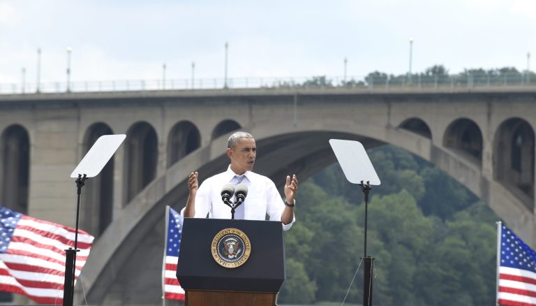 With the Key Bridge in the background, President Obama speaks about the economy and transportation, Tuesday at Georgetown Waterfront Park in Washington. (AP/Susan Walsh)