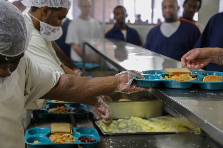 Inmates are served food through the Aramark Correctional Services on Tuesday June 24, 2014 at The Charles E. Egeler Reception and Guidance Center in Jackson, Mich. An overseer hired by the state after a series of problems says Michigan's prison food service contractor will boost worker pay, staffing levels and training. (AP Photo/Detroit Free Press, Ryan Garza) DETROIT NEWS OUT, TV OUT, INTERNET OUT, MAGS OUT, NO SALES, MANDATORY CREDIT DETROIT FREE PRESS