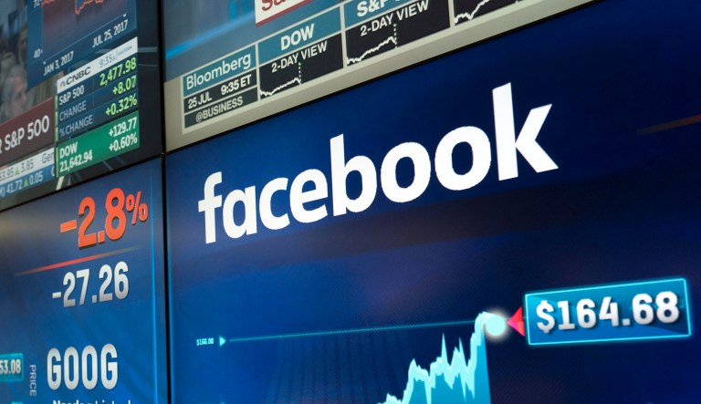 Alphabet and Facebook stock values are shown on a screen at the Nasdaq MarketSite, Tuesday, July 25, 2017, in New York.