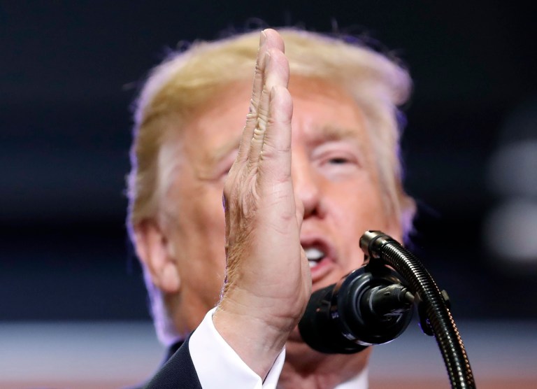 At the Phoenix rally Tuesday, the president pulled out a copy and read from his original statement in response to the violence at a rally in support of a Confederate monument in central Virginia. (AP Photo)