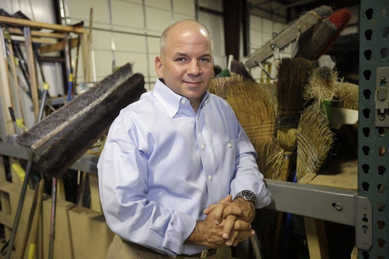 In this photo taken Monday, May 26, 2014, CEO Joe Carter poses in the warehouse at Snyder Environmental in Maumelle, Ark. Carter wants to hire workers to expand his company that removes asbestos, lead paint and other toxic materials from buildings. Snyder Environmental has two problems: It needs money, and it needs people willing and able to do the work. (AP Photo/Danny Johnston)