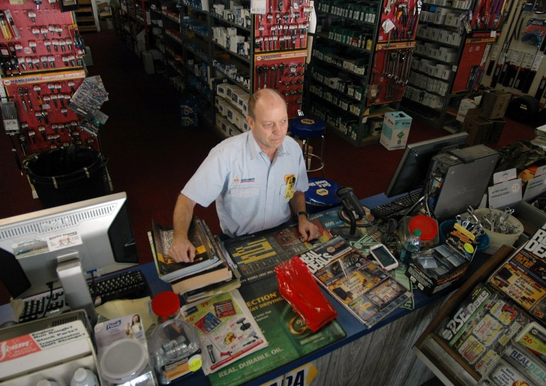   In this Tuesday, Dec. 4, 2012 photo, Jimmy Barton, speaking with a customer at his auto parts store in Lineville, Ala., favors legalizing alcohol sales in Clay County, the last completely dry county in Alabama. Barton, who once bought alcohol from bootleggers illegally, believes legalizing beer and whiskey would help the poor county develop economically. (AP Photo/Jay Reeves)  