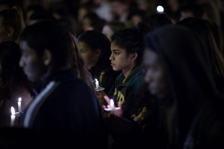 People hold candles during a vigil on Emory University's campus Monday, Nov. 16, 2015, in Atlanta, to honor the victims of Friday's attacks in Paris. (AP Photo/Branden Camp)