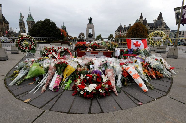 Floral tributes to Cpl. Nathan Cirillo sit at the National War Memorial in Ottawa, Ontario on Thursday. Canadians are mourning the loss of Cirillo, the army reservist who was shot dead as he stood guard before the Tomb of the Unknown soldier on Wednesday. Flags were flown at half-staff to honor Cirillo, a 24-year-old a reservist from Hamilton, Ontario, whose shooting on Wednesday began an attack that ended with a lone gunman storming into Parliament and opening fire before being shot dead himself. (AP Photo/The Canadian Press, Sean Kilpatrick)