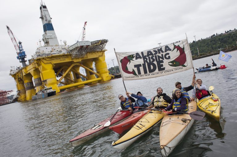 Environmental activists hold a sign during ShellNo flotilla demonstrations against Royal Dutch Shell near the Polar Pioneer oil drilling rig on May 16, 2015 in Seattle, Wash. On Saturday demonstrators began three days of protests both on land and on Puget Sound over the presence of the first of two Royal Dutch Shell oil rigs in the Port of Seattle. (Photo by David Ryder/Getty Images)