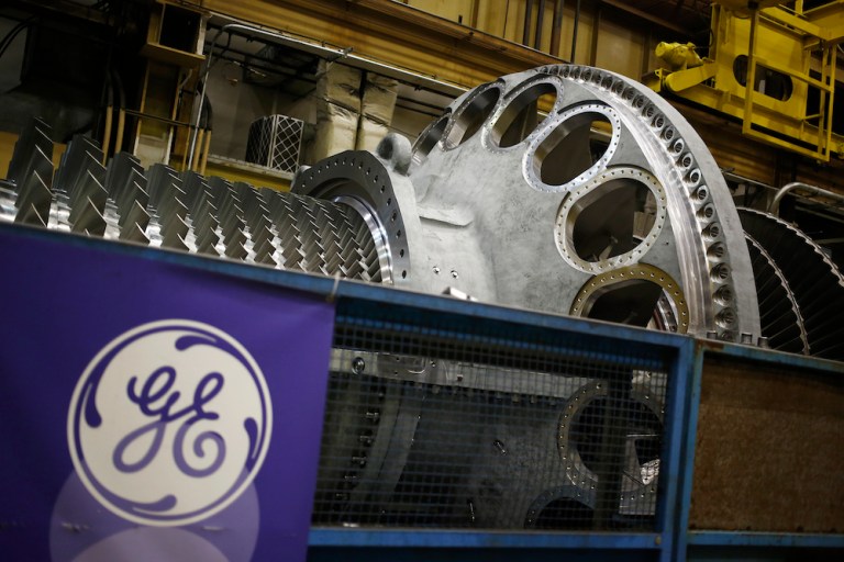 A logo is displayed next to a gas turbine at GE's energy plant in Greenville, S.C. A $31 billion pension-funding gap at the iconic manufacturer may be narrowed by rising interest rates. (Luke Sharrett/Bloomberg)