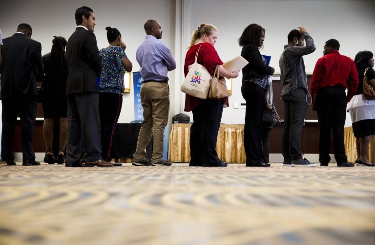 In this June 23, 2014 photo, job seekers wait in line to meet with recruiters during a job fair in Philadelphia. The government issues the July jobs report on Friday, Aug. 1, 2014. (AP Photo/Matt Rourke)