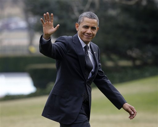 President Barack Obama waves as he walks across the South Lawn of the White House in Washington, Thursday, Feb. 7, 2013, following his arrival on Marine One helicopter from the House Democratic Issues Conference in Lansdowne, Va. (AP Photo/Pablo Martinez Monsivais)