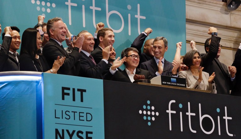 Fitbit CEO James Park, center, is applauded as he rings the New York Stock Exchange opening bell, to mark the company's IPO, Thursday, June 18, 2015. Shares of Fitbit are up 55 percent in the first day of trading for the fitness tracking gear maker. 