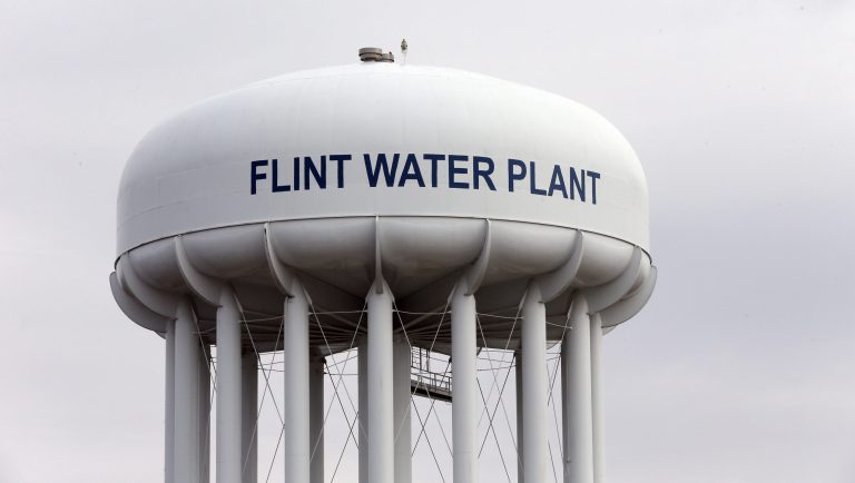 The Flint Water Plant tower is seen, Friday, Feb. 5, 2016 in Flint, Mich. Flint is under a public health emergency after its drinking water became tainted when the city switched from the Detroit system and began drawing from the Flint River in April 2014 to save money. The city was under state management at the time.  