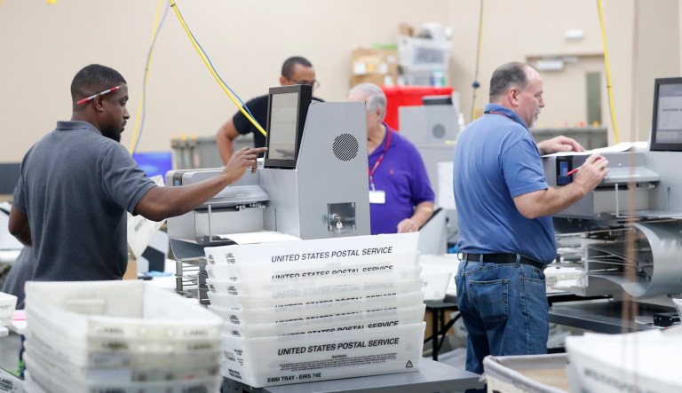 Employees at the Broward County Supervisor of Elections office count ballots from the Mid-term election, Thursday, Nov. 8, 2018, in Lauderhill, Fla.