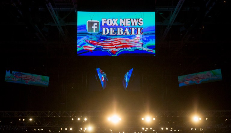 A Fox News Debate sign is displayed on video screens above the debate stage ahead of the first Republican presidential debate at Quicken Loans Arena in Cleveland, Ohio, U.S., on Thursday, Aug. 6, 2015. The first Republican presidential debate, hosted by Fox News and Facebook Inc. in conjunction with the Ohio Republican Party, will be held Thursday night. 