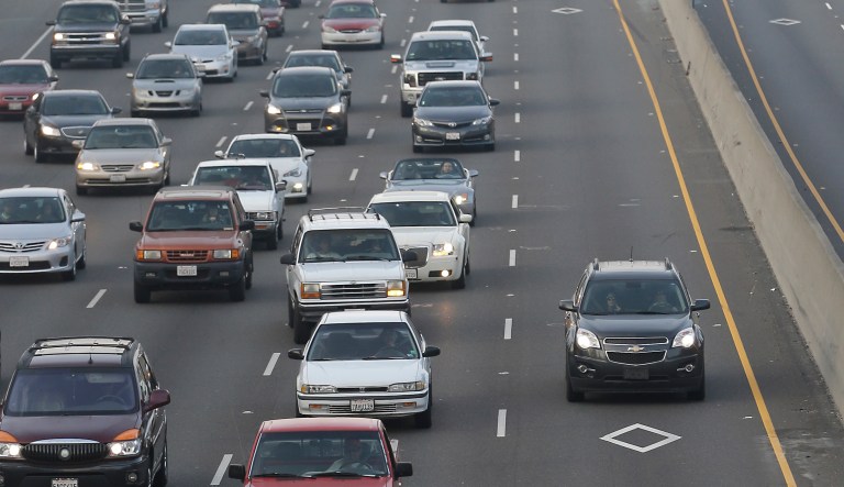FILE -- In this Feb. 4, 2015 file photo,  a vehicle in the High Occupancy Vehicle lane, on right, passes lines of slow moving cars on Southbound Highway 99 in Sacramento, Calif.