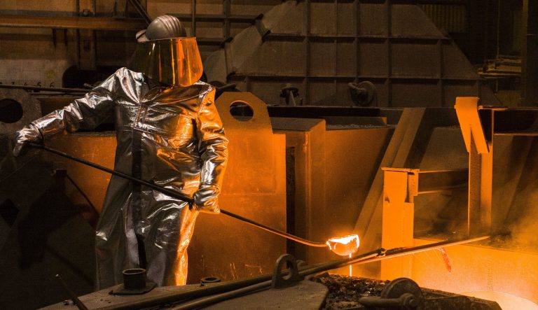 An employee in protective clothing takes a sample from the furnace at the steel producer Salzgitter AG in Salzgitter, Germany.