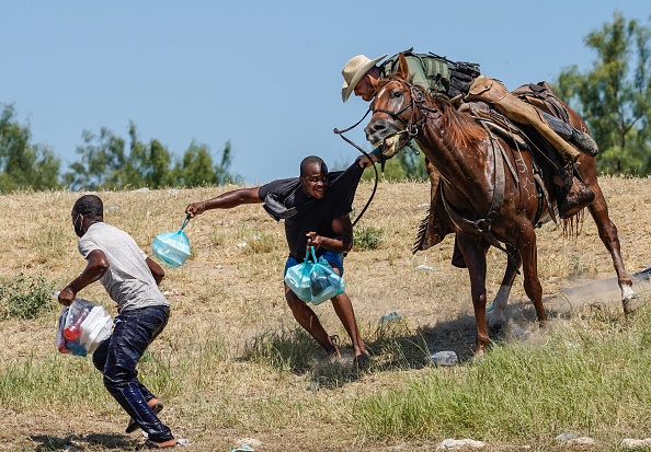 TOPSHOT - A United States Border Patrol agent on horseback tries to stop a Haitian migrant from entering an encampment on the banks of the Rio Grande near the Acuna Del Rio International Bridge in Del Rio, Texas on September 19, 2021. - (Photo by PAUL RATJE / AFP) (Photo by PAUL RATJE/AFP via Getty Images)