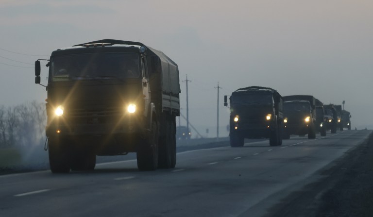 A convoy of Russian military vehicles is seen as the vehicles move toward the border in the Donbas region of eastern Ukraine on Feb. 23, 2022, in the Russian border city of Rostov. 