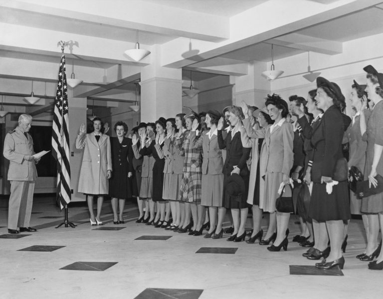 Capt. Kenneth Castleman administers the oath of allegiance to the first intake of trainee officer candidates of the United States Naval Reserve (Women's Reserve), better known as the WAVES (Women Accepted for Volunteer Emergency Service), to begin training for the women's service on Sept. 7, 1942, at the U.S. Naval Training Station at Smith College in Northampton, Massachusetts.