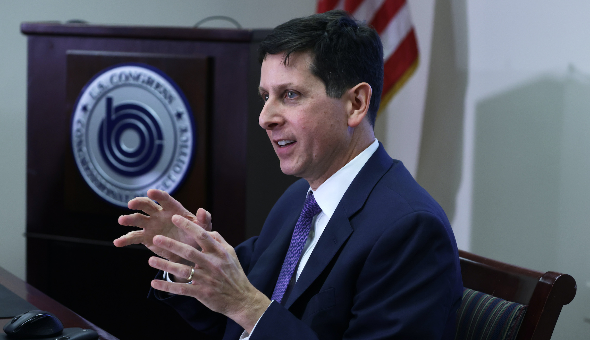 Balancing budget over next decade may require cuts to federal programs, CBO says