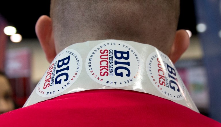 Jake Dagel, Iowa Field Coordinator for Turning Point USA, wears "Big Government Sucks" stickers around his neck during the Conservative Political Action Conference (CPAC) in National Harbor, Md., Friday, Feb. 27, 2015.