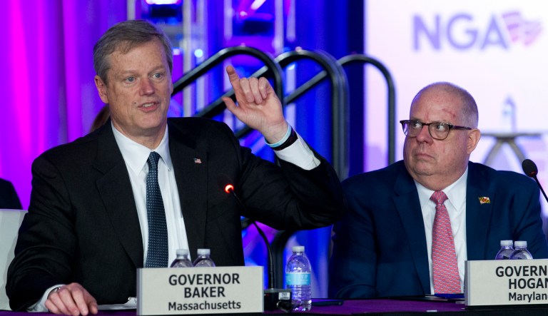 Gov. Charlie Baker of Massachusetts accompanied by Gov. Larry Hogan of Maryland, speaks during the panel The Opioid Crisis, at the National Governor Association 2018 winter meeting, on Saturday, Feb. 24, 2018, in Washington.