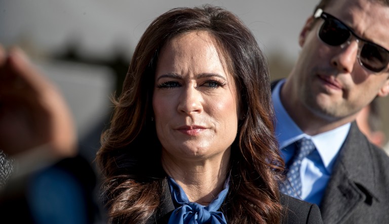 White House press secretary Stephanie Grisham listens as President Donald Trump speaks to reporters on the South Lawn of the White House in Washington, Friday, Nov. 8, 2019, before boarding Marine One for a short trip to Andrews Air Force Base, Md. and then on to Georgia to meet with supporters.