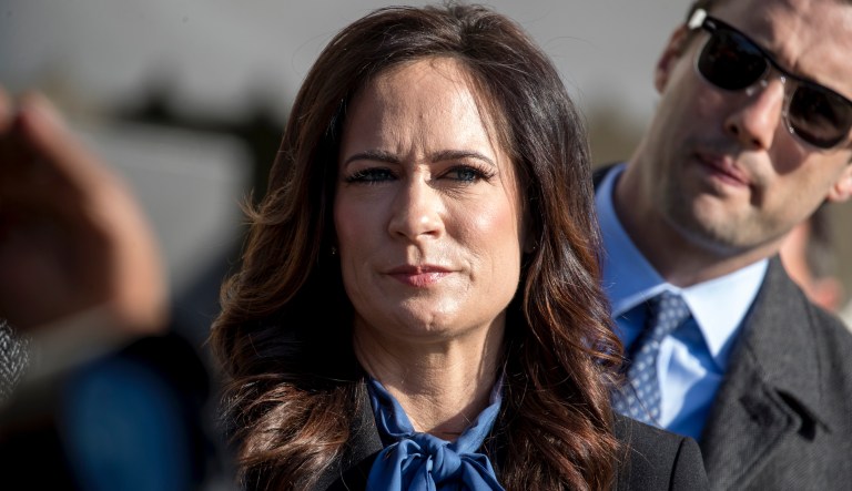 White House press secretary Stephanie Grisham listens as President Donald Trump speaks to reporters on the South Lawn of the White House in Washington, Friday, Nov. 8, 2019, before boarding Marine One for a short trip to Andrews Air Force Base, Md. and then on to Georgia to meet with supporters.