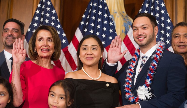House Speaker Nancy Pelosi of Calif., right, poses during a ceremonial swearing-in with Delegate Michael San Nicolas, D-Guam, on Capitol Hill in Washington, Thursday, Jan. 3, 2019.