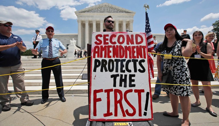An Israeli shoots his weapon at a gun range near the West Bank Jewish settlement of Givat Zeev, Sunday, Oct. 11, 2015.
