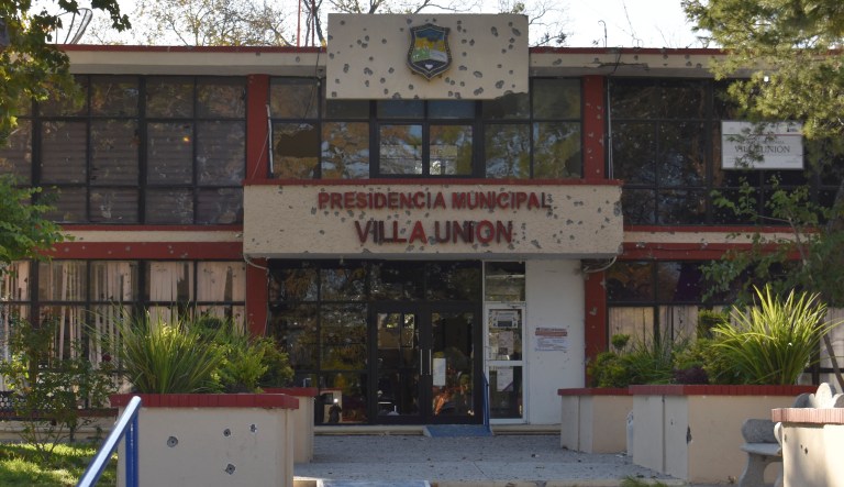 The City Hall of Villa Union is riddled with bullet holes after a gun battle between Mexican security forces and suspected cartel gunmen, Saturday, Nov. 30, 2019. At least 14 people were killed, four of them police officers, after an armed group in a convoy of trucks stormed the town, in Coahuila state, prompting security forces to intervene, state Gov. Miguel Riquelme Solis said.