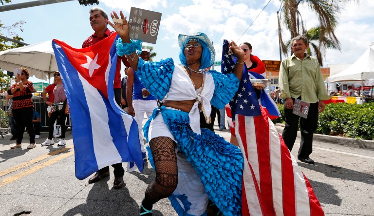 Lucina Michel, right, and her husband Caridad Osorio wave American and Cuban flags as they dance to music at the Calle Ocho Festival, Sunday, March 11, 2018, in Miami. The one-day event billed as the largest Hispanic festival in the country attracts thousands to the Little Havana neighborhood of Miami.