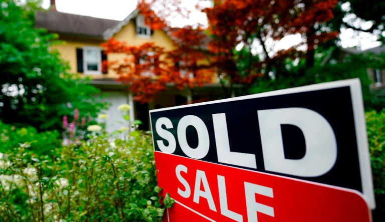 A sale sign stands outside a home in Wyndmoor, Pa., Wednesday, June 22, 2022. Existing home sales plunged in July as fears of a recession grow.