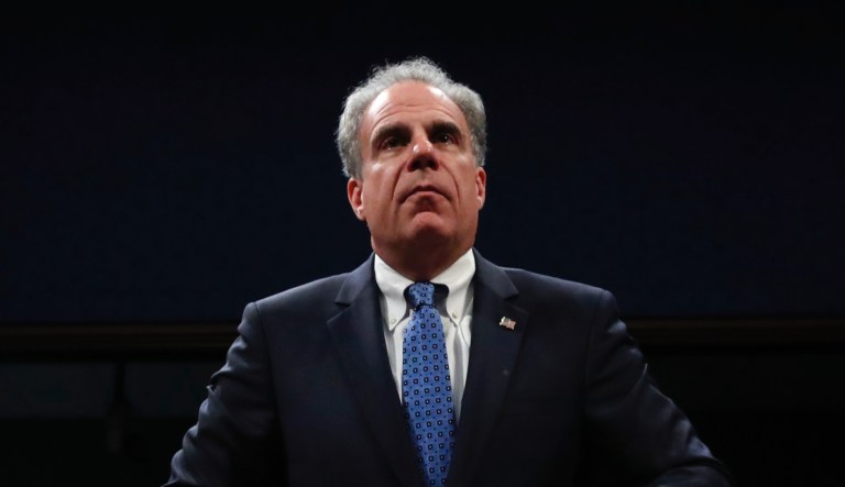Department of Justice Inspector General Michael Horowitz  adjusts his coat before being sworn in for a joint House Committee on the Judiciary and House Committee on Oversight and Government Reform hearing examining his report of the FBIâs Clinton email probe, on Capitol Hill, Tuesday, June 19, 2018 in Washington.