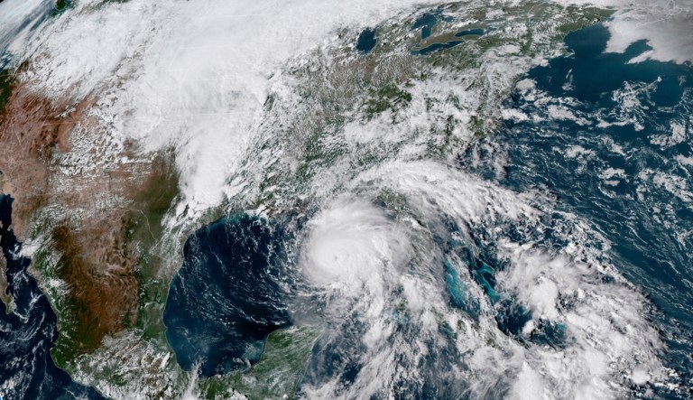 This satellite image made available by NOAA shows Hurricane Michael, center, in the Gulf of Mexico on Tuesday, Oct. 9, 2018 at 3:17 p.m. EDT.