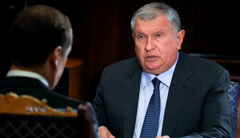 Russian Prime Minister Dmitry Medvedev, back to camera, listens to Rosneft Russian oil giant chief Igor Sechin during a meeting in the Gorky residence outside Moscow, Russia, Tuesday, Oct. 1, 2019.