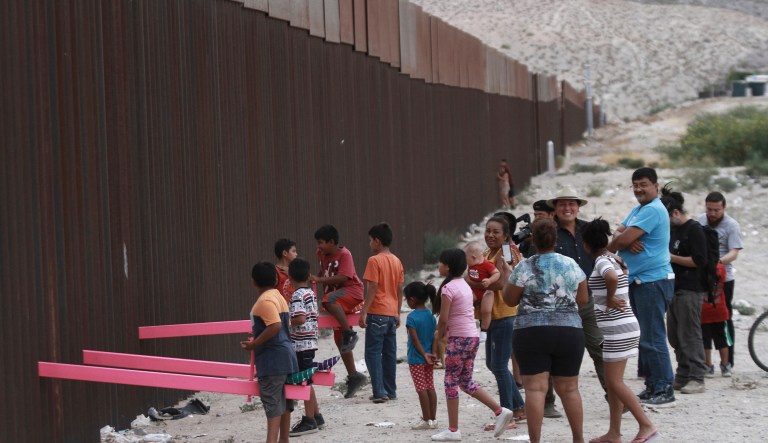 Children play seesaw installed between the border fence that divides Mexico from the United States in Ciudad de Juarez, Mexico, Sunday, July 28, 2019. 