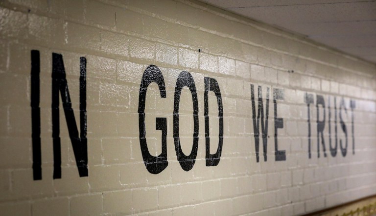 This July 23, 2019 photo shows "In God We Trust" stenciled in a wall at South Park Elementary in Rapid City, S.D. 