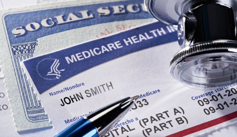  Medicare Health Insurance and Social Security card on medical report with stethoscope.