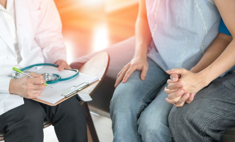 A fertility doctor with a man and woman.