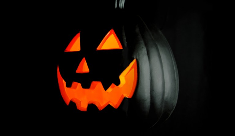 Close-up of a Jack O' Lantern with a black background. 