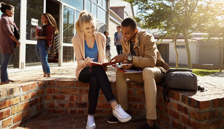 Shot of two students studying together on campus.